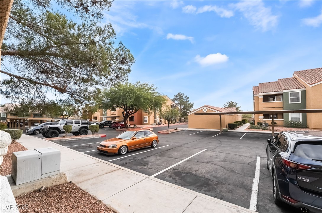 8101 West Flamingo Road, Unit 1090 Las Vegas, NV 89147 - Photo 28 of 30 Uncovered parking lot with a residential view
