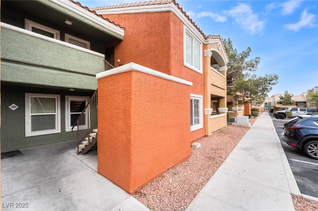 8101 West Flamingo Road, Unit 1090 Las Vegas, NV 89147 - Photo 4 of 30 View of home's exterior featuring a tile roof, stucco siding, and a balcony