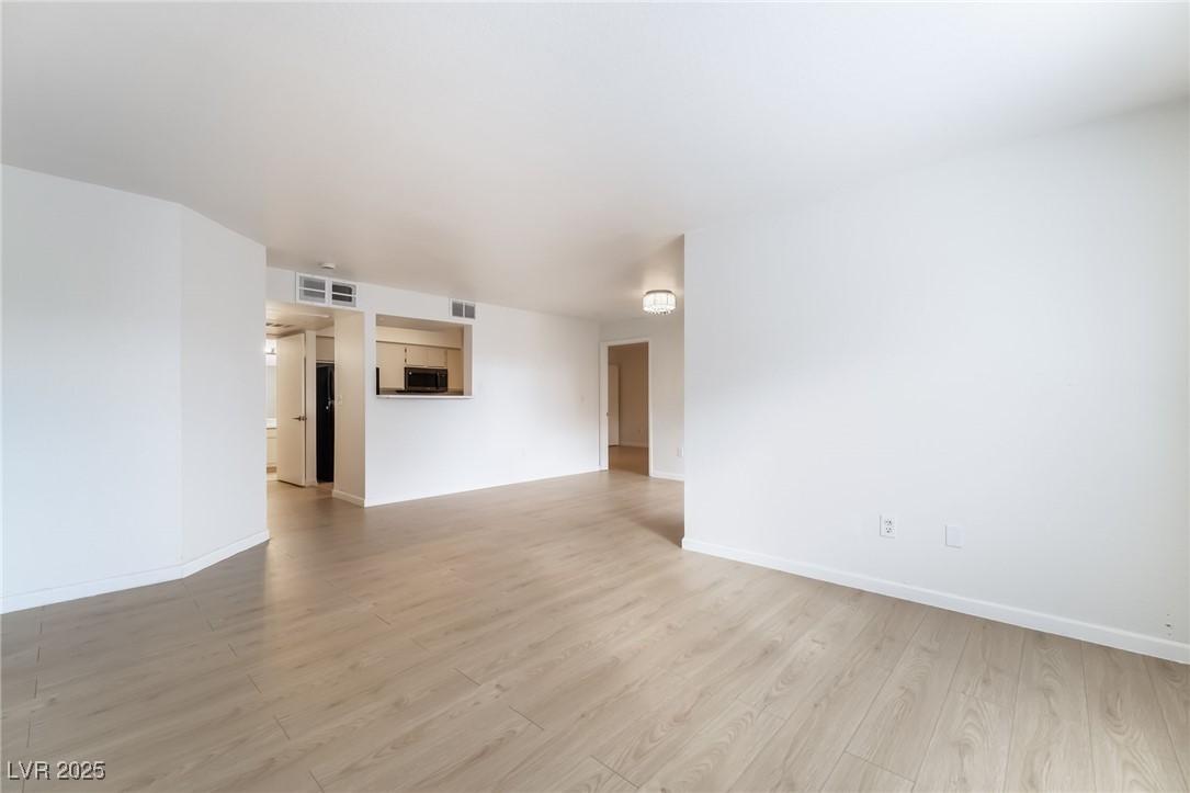 8101 West Flamingo Road, Unit 1090 Las Vegas, NV 89147 - Photo 7 of 30 Spare room with light wood-style flooring and baseboards