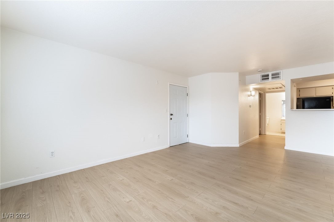 8101 West Flamingo Road, Unit 1090 Las Vegas, NV 89147 - Photo 8 of 30 Empty room with baseboards and light wood finished floors