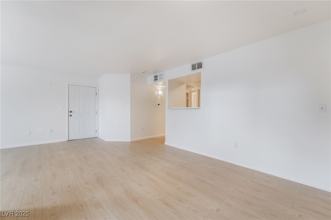 8101 West Flamingo Road, Unit 1090 Las Vegas, NV 89147 - Photo 10 of 30 Empty room with light wood-style floors and baseboards