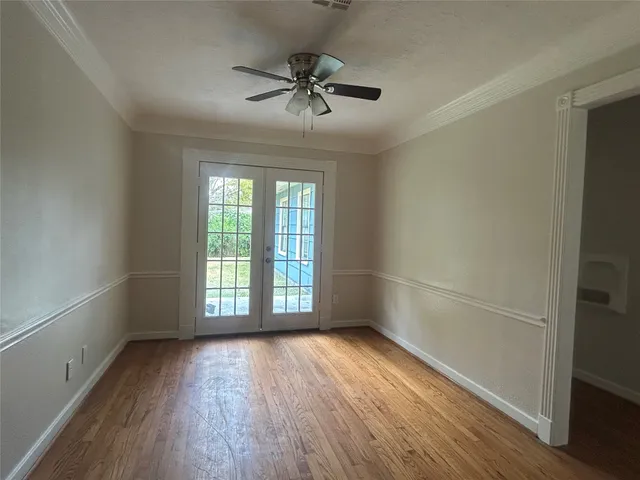 wooden floor in an empty room with a window
