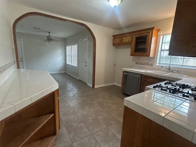a kitchen with a sink appliances and cabinets