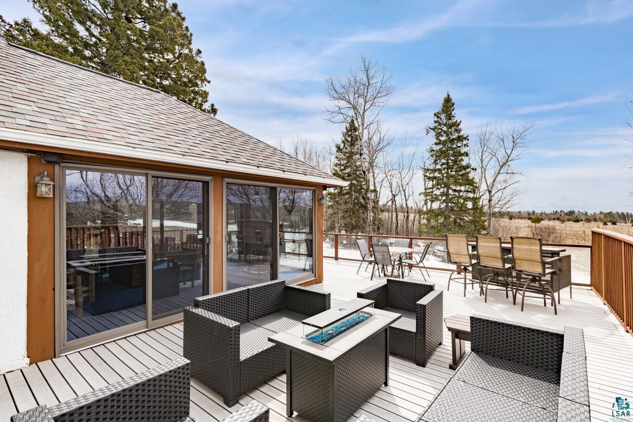 2170 Lester River Road Duluth, MN 55804 - Photo 17 of 66 Wooden terrace with an outdoor fire pit, a sunroom, and outdoor lounge area