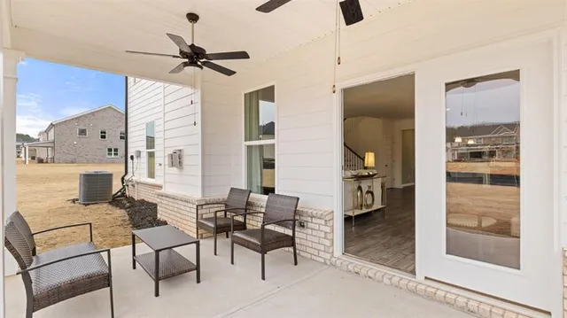 a living room with furniture a fireplace and a large mirror