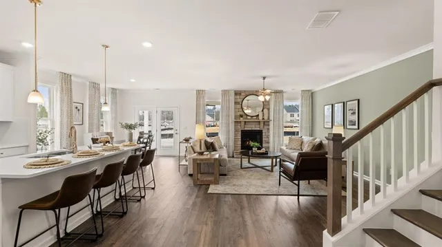 a living room with furniture a mirror and a fireplace