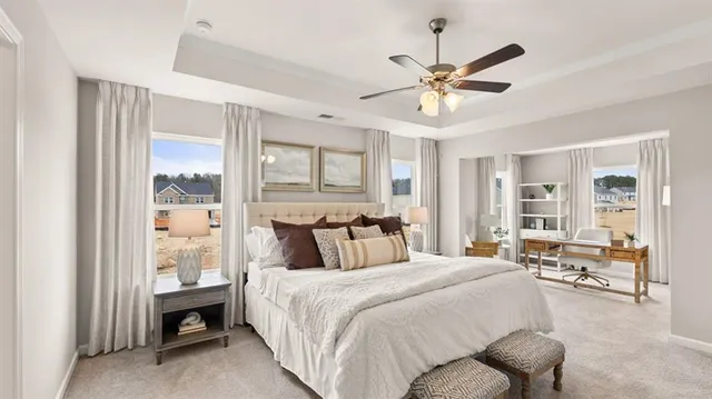 a spacious bedroom with a large bed and a chandelier