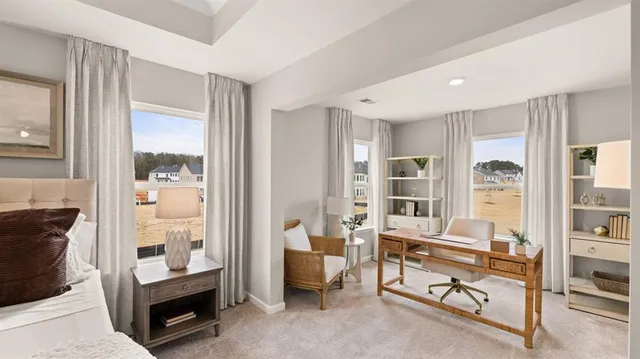 a bedroom with a bed and a large window