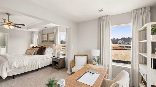 a bedroom with a bed a lamp and a dresser