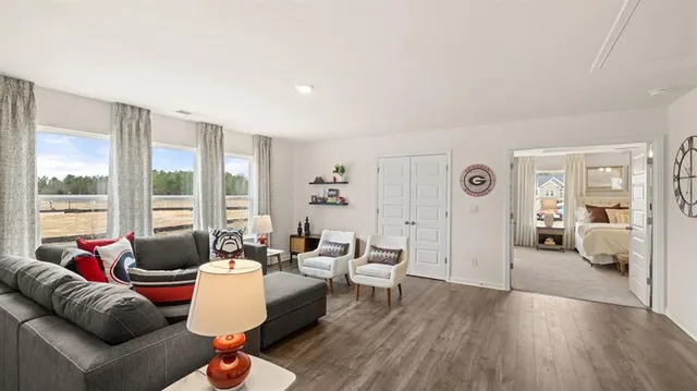 a view of a hallway with wooden floor and closet area