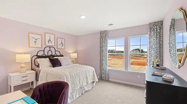 a bedroom with a bed and a table in it