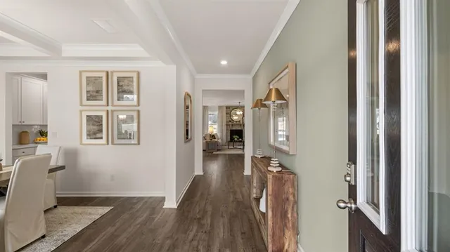 a dining room with wooden floor a chandelier a wooden table and chairs