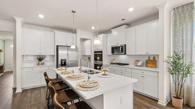 a kitchen with a sink appliances and a refrigerator