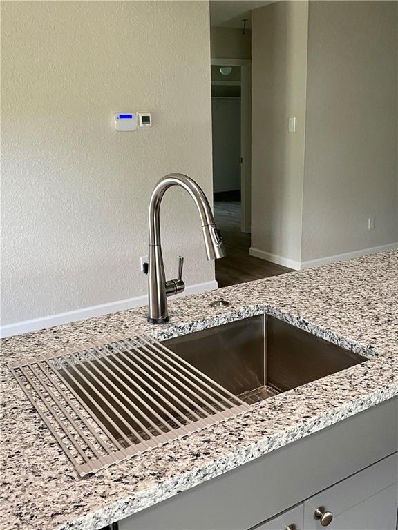 1715 Shadowview Drive, Unit B Austin, TX 78758 - Photo 16 of 28 Premium granite counters and a gleaming stainless steel sink elevate this kitchen's appeal.