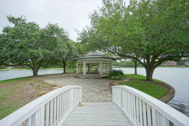 a view of a house with a yard and tree s