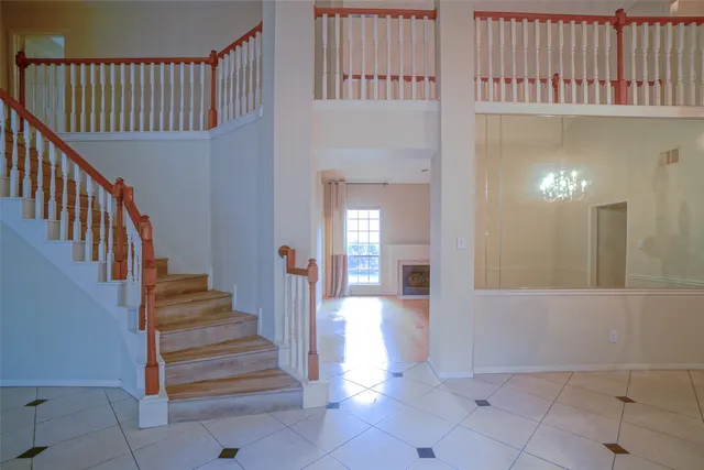 a view of a hallway with entryway and hall with wooden floor