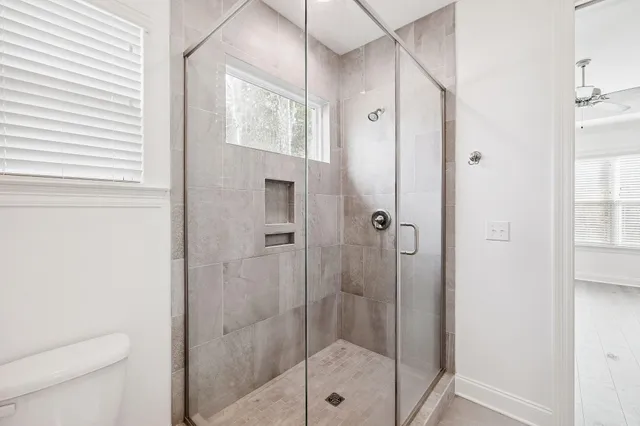 a bathroom with a shower and toilet