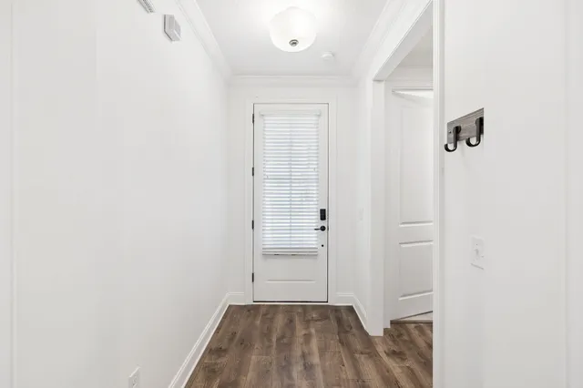 view of a room with wooden floor and white doors