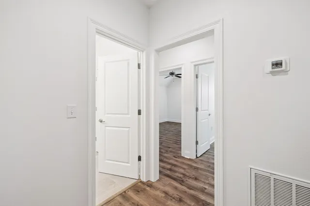 a view of a hallway with wooden floor