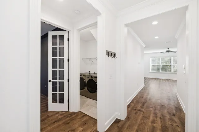 a view of a bedroom with wooden floor and a window