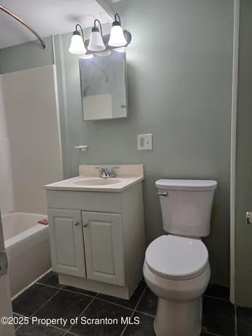 a bathroom with a sink toilet and a mirror