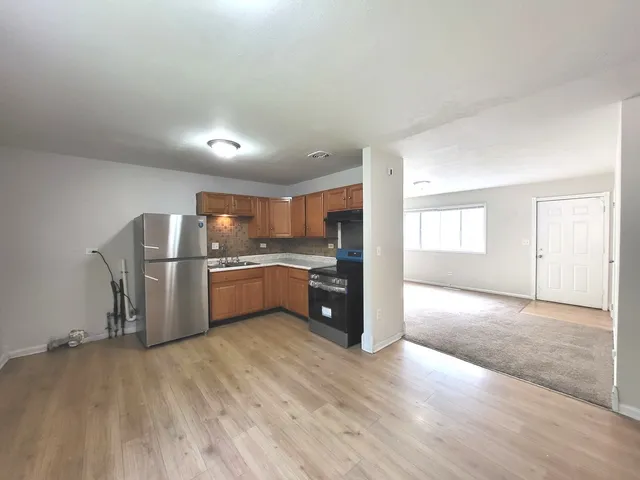 a kitchen with a refrigerator and a sink