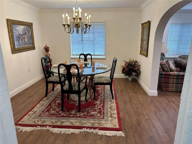 a view of a dining room with furniture wooden floor and a chandelier