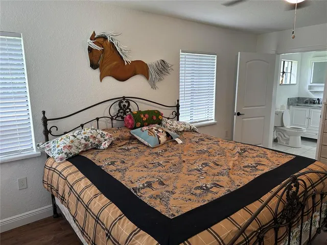 a bed sitting in a bedroom next to a window