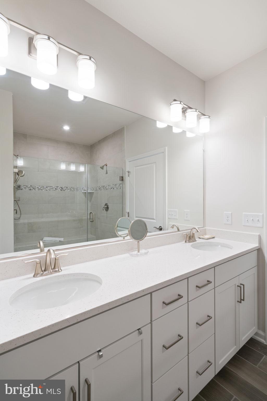15795 Gardenia Rdg Way Haymarket, VA 20169 - Photo 19 of 63 a bathroom with a double vanity sink and a mirror