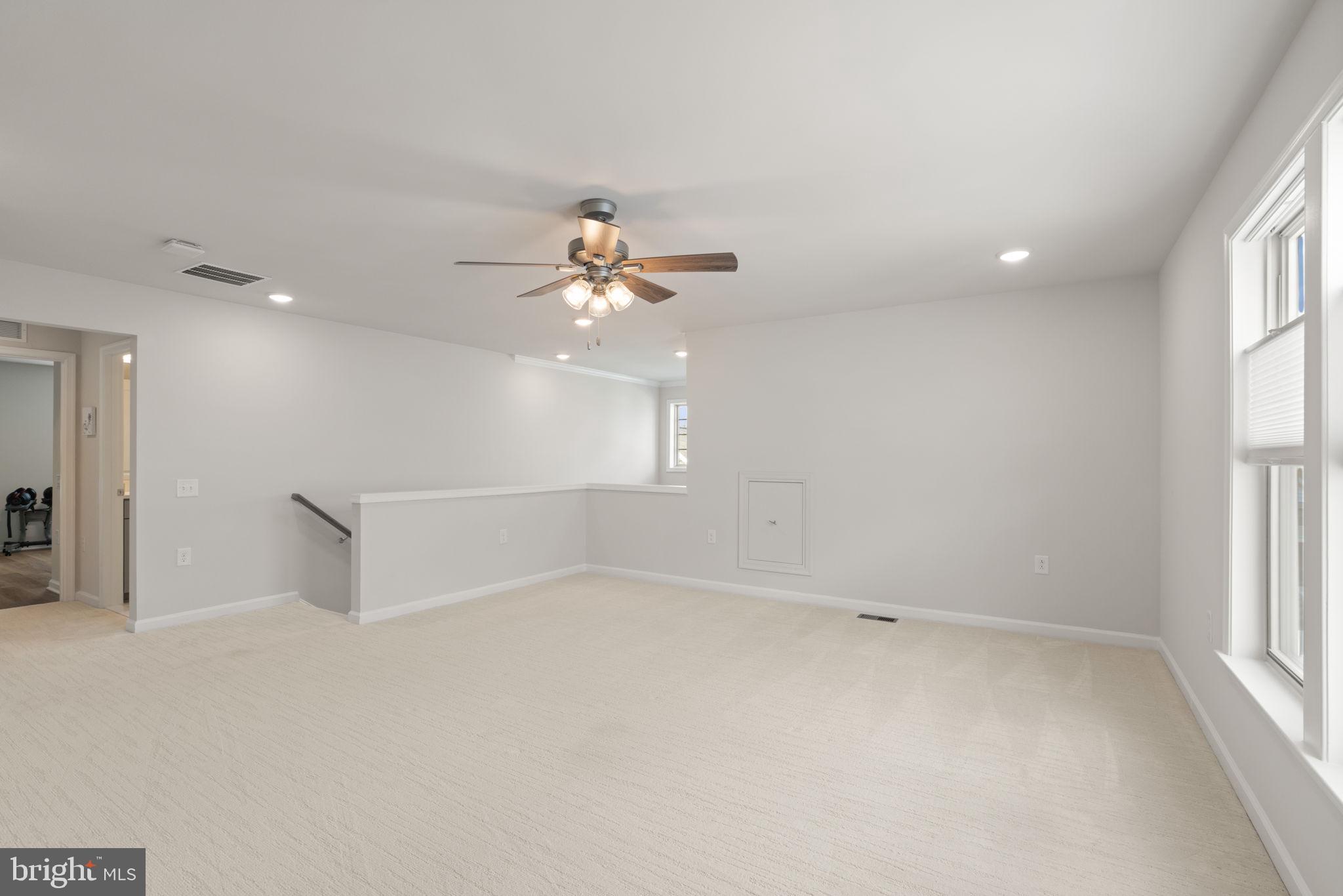 15795 Gardenia Rdg Way Haymarket, VA 20169 - Photo 24 of 63 an empty room with windows and chandelier fan