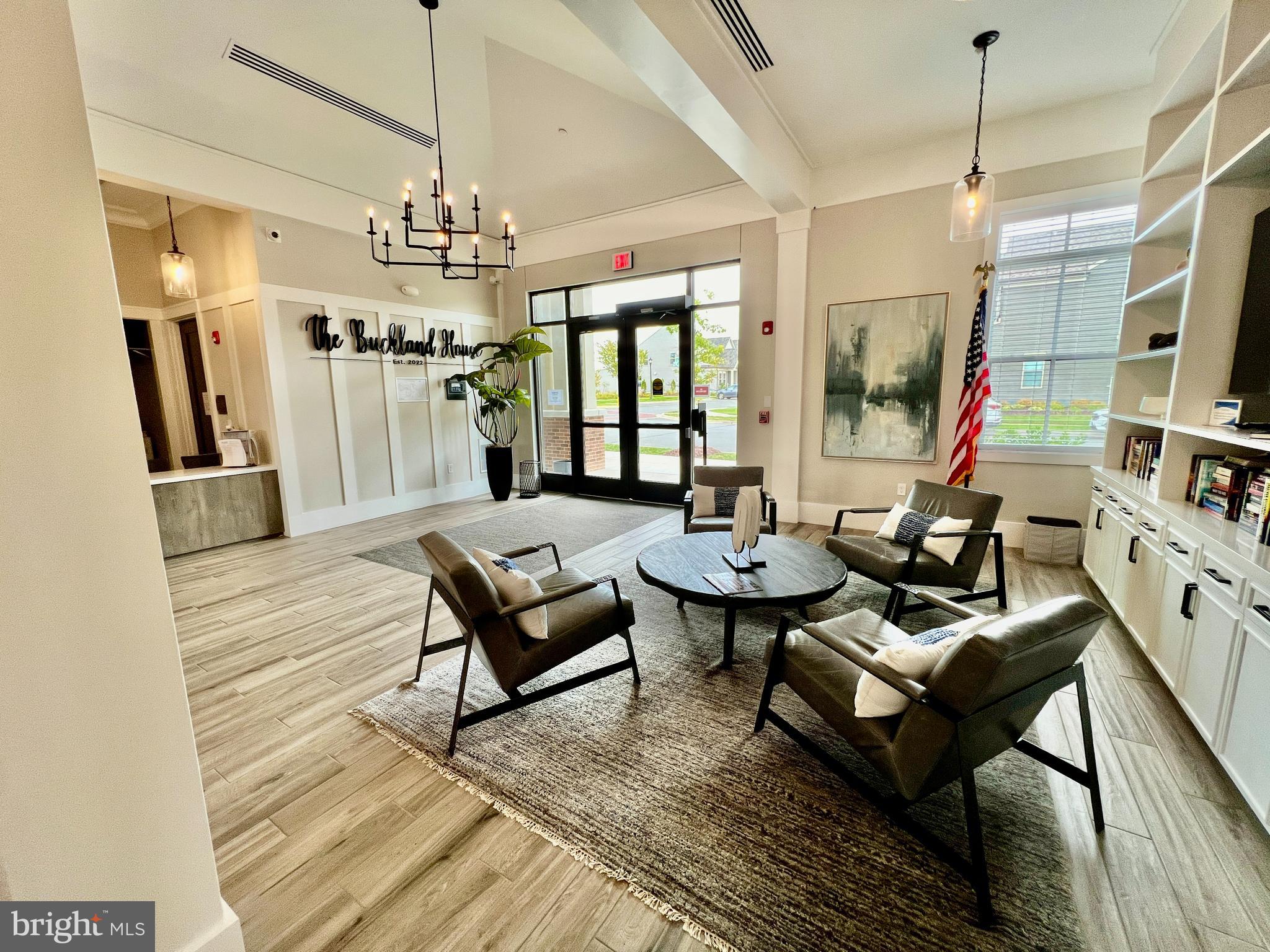 15795 Gardenia Rdg Way Haymarket, VA 20169 - Photo 42 of 63 a living room with furniture or chandelier and a wooden floor