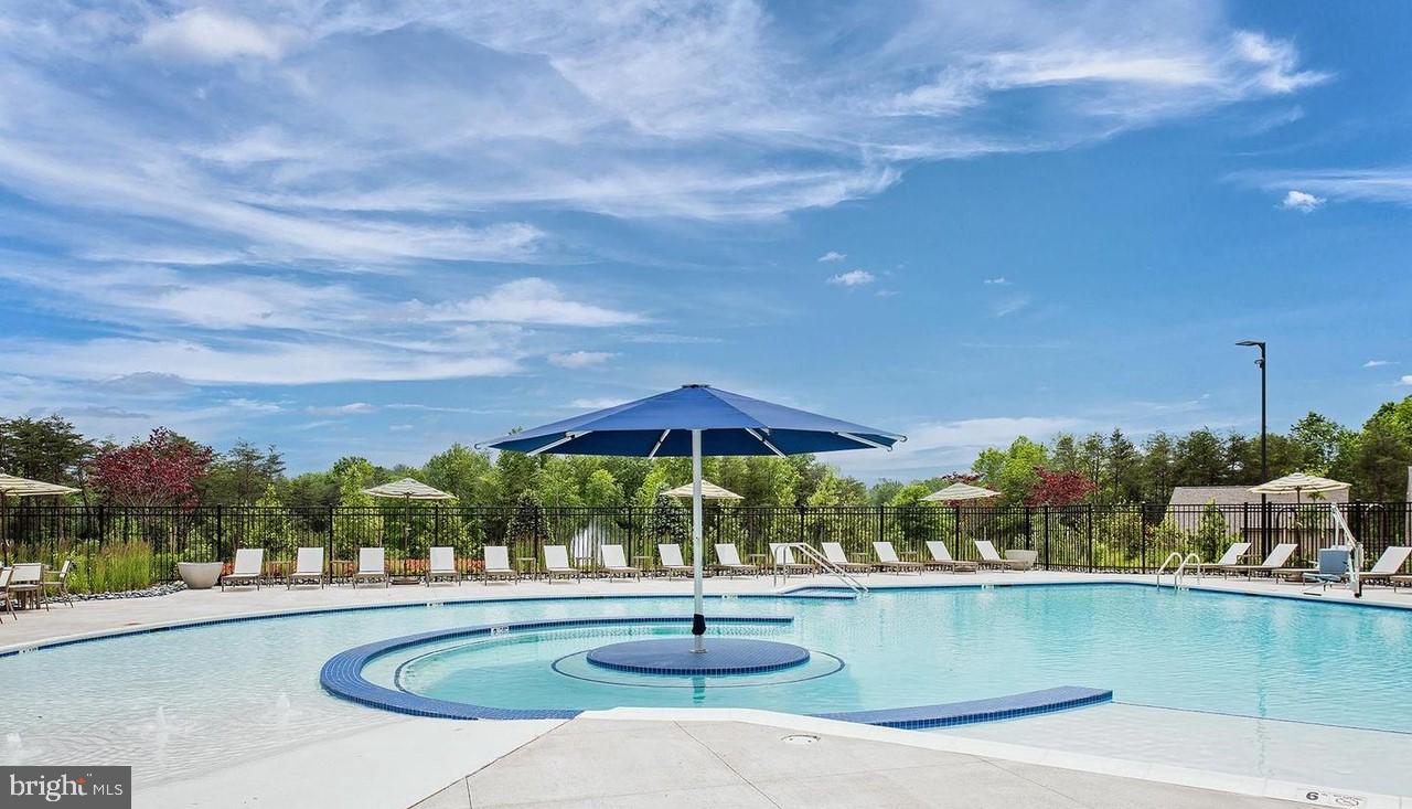 15795 Gardenia Rdg Way Haymarket, VA 20169 - Photo 44 of 63 a view of a swimming pool and a chairs