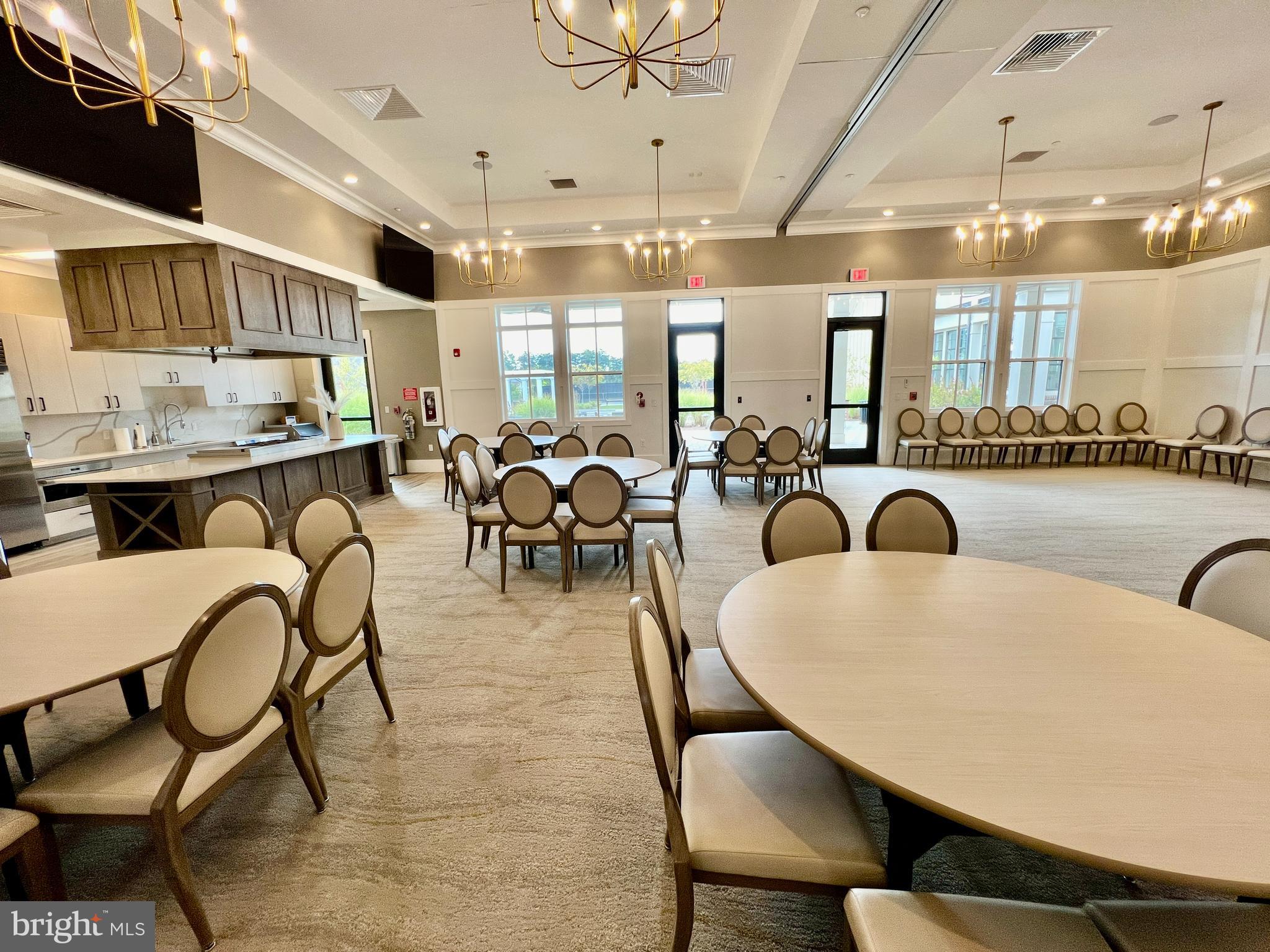 15795 Gardenia Rdg Way Haymarket, VA 20169 - Photo 52 of 63 a dining room with furniture a chandelier and a flat screen tv