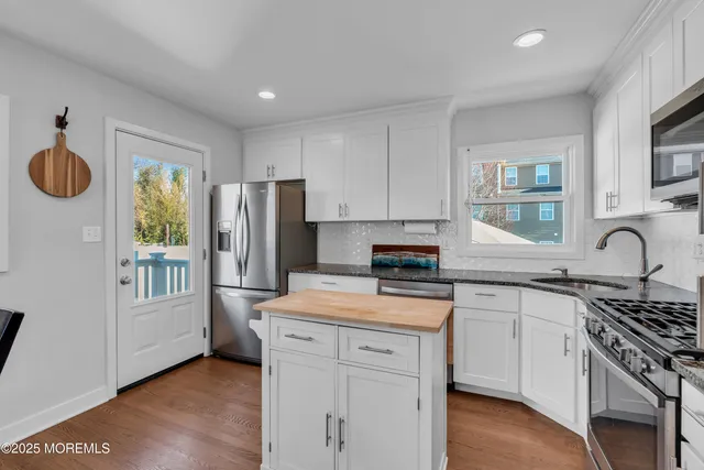 a kitchen with a refrigerator and a stove top oven