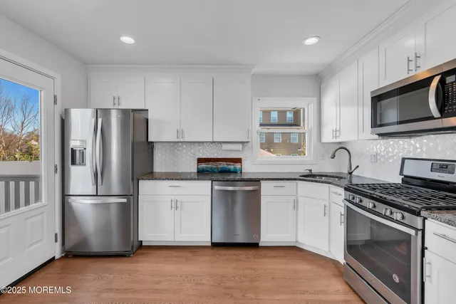 a kitchen with stainless steel appliances a refrigerator stove and microwave