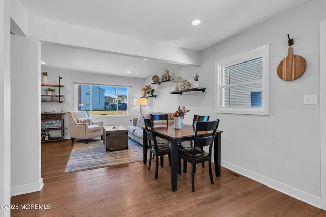 a view of a dining room with furniture and a potted plant