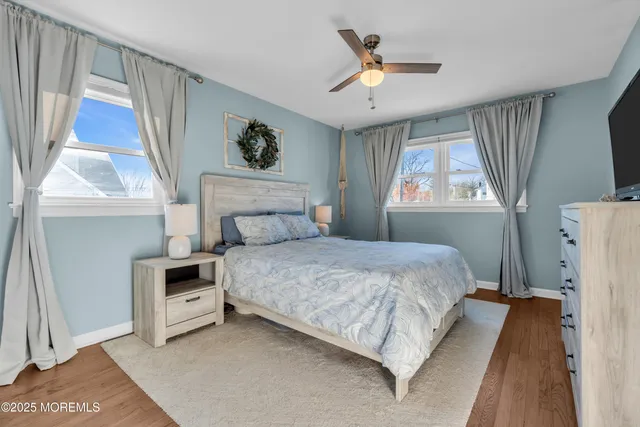 a bedroom with a bed next to a window with a chandelier