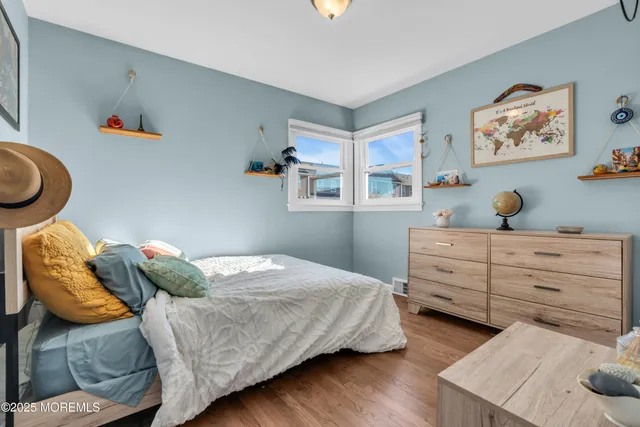 a bedroom with a bed and paintings on the wall