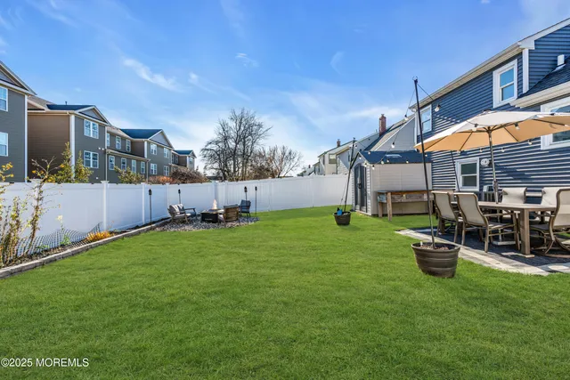 a backyard of a house with table and chairs