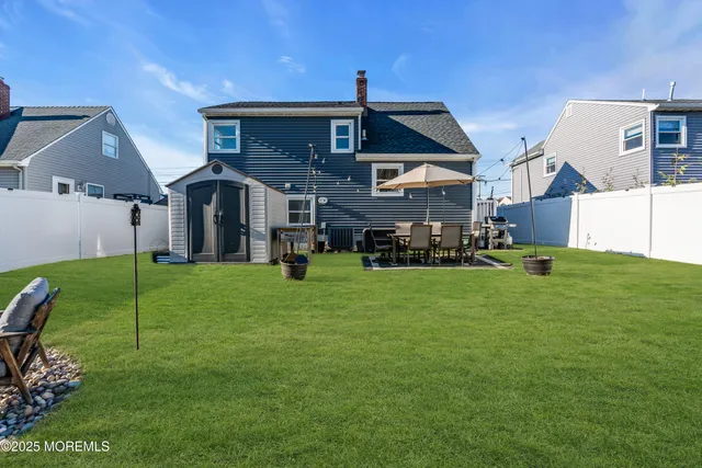 a front view of a house with a yard table and chairs