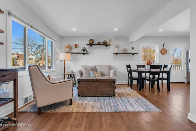 a living room with furniture and wooden floor