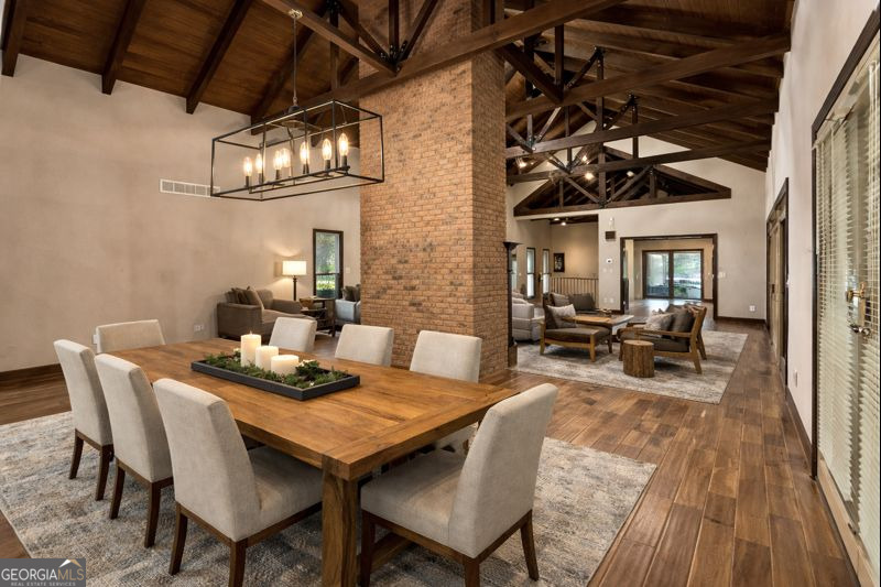 1140 Highway 54 Moreland, GA 30259 - Photo 15 of 39 a view of a dining room with furniture a chandelier and wooden floor