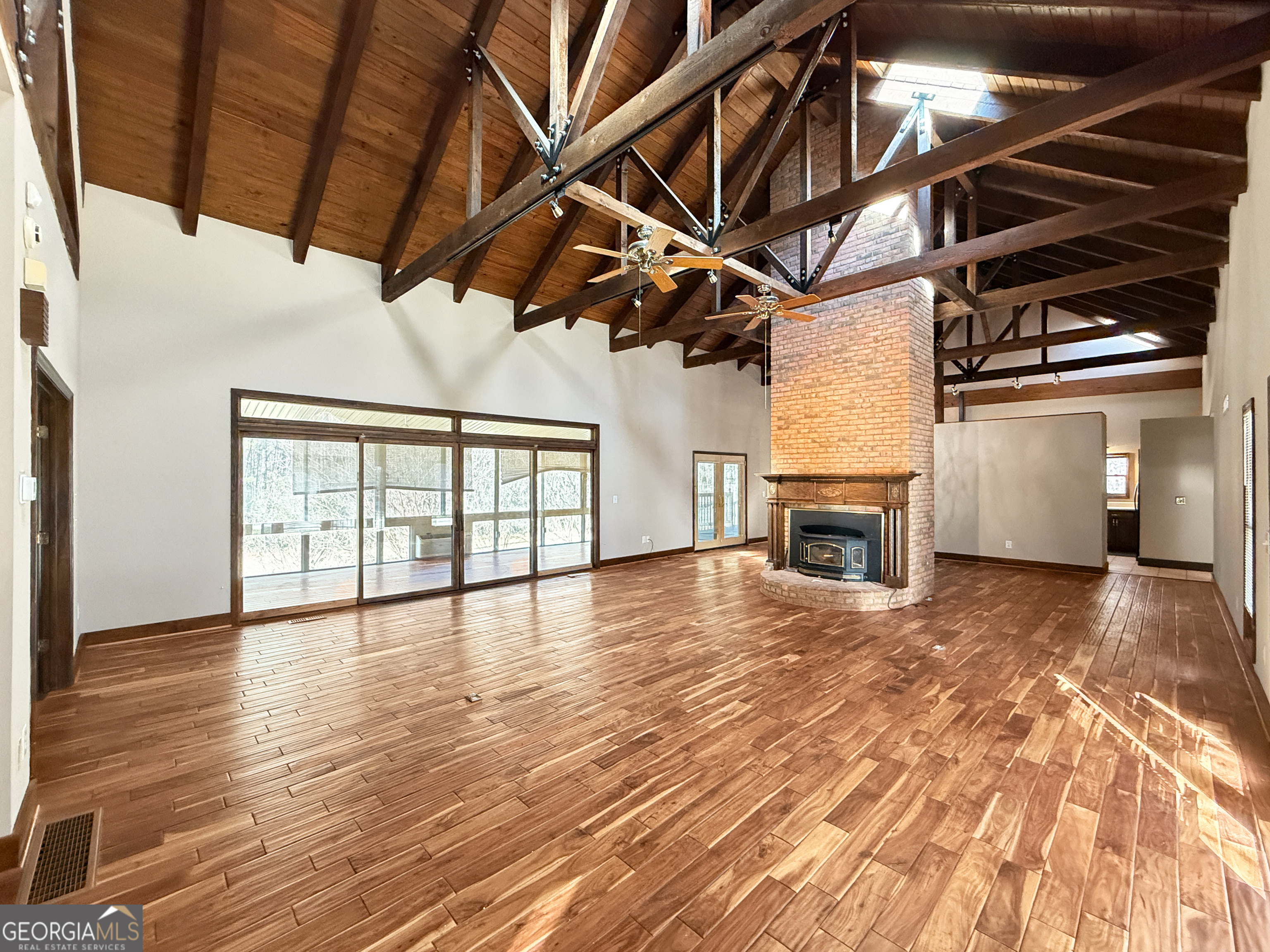 1140 Highway 54 Moreland, GA 30259 - Photo 7 of 39 a view of empty room with wooden floor and fireplace