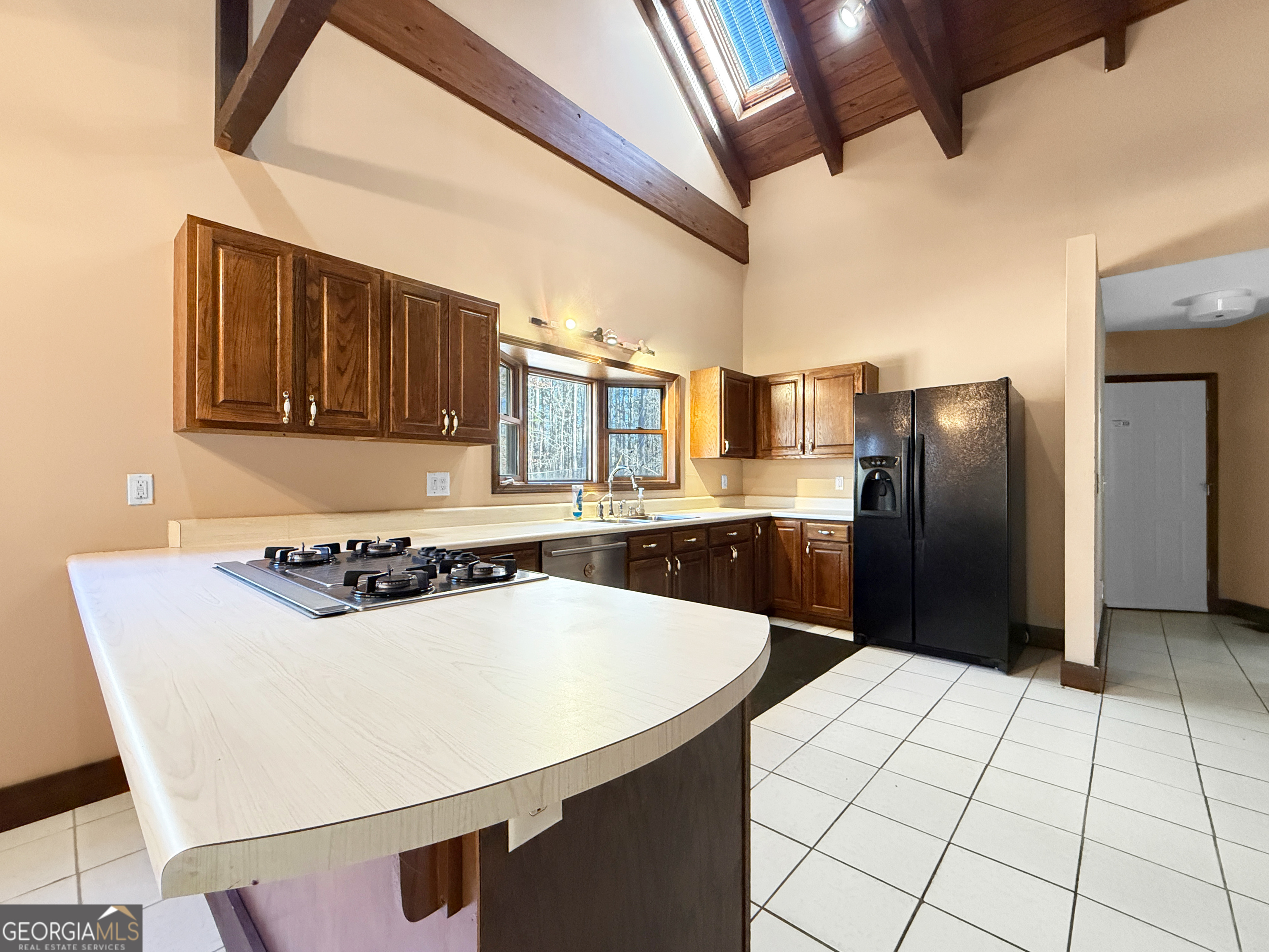 1140 Highway 54 Moreland, GA 30259 - Photo 10 of 39 a kitchen with stainless steel appliances a refrigerator sink and cabinets