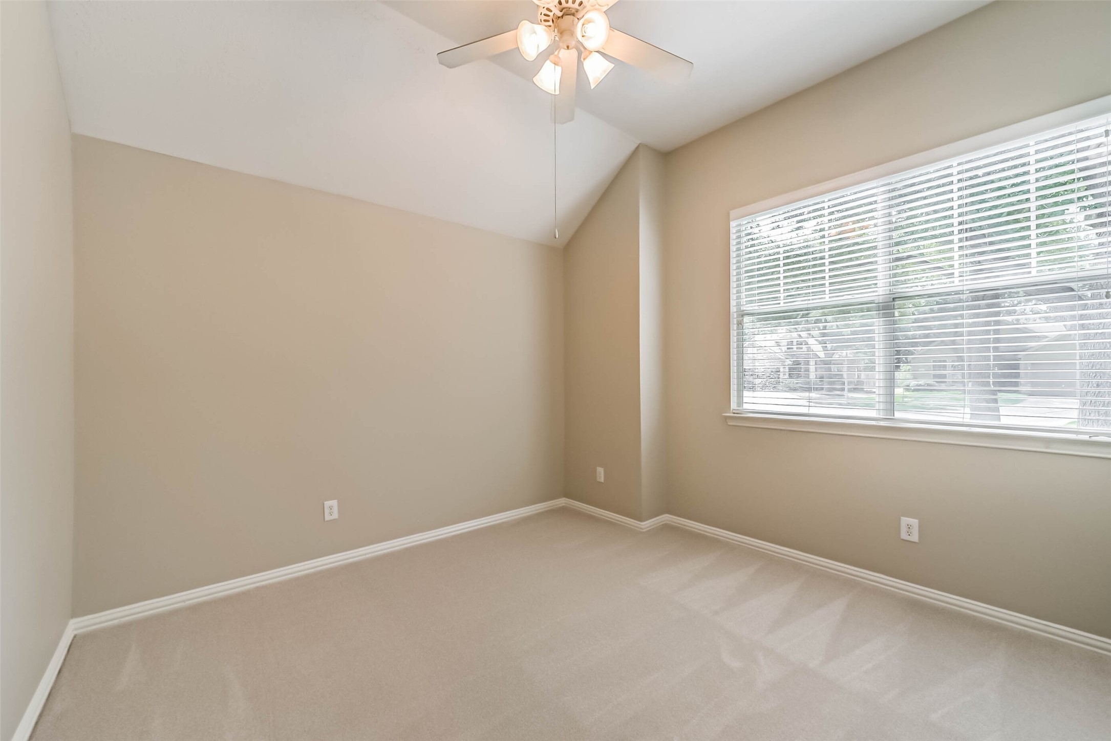 30910 Blue Ridge Park Lane Spring, TX 77386 - Photo 35 of 50 Bright, inviting room with neutral tones, vaulted ceiling, and a large window for natural light, perfect for a cozy retreat or home office.