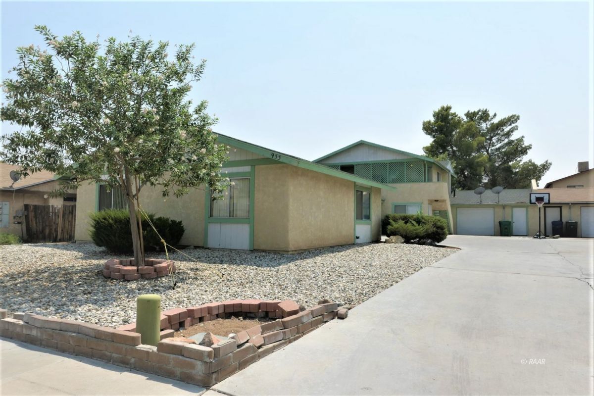 933 West Perdew Avenue Ridgecrest, CA 93555 - Photo 1 of 21 a front view of a house with garden