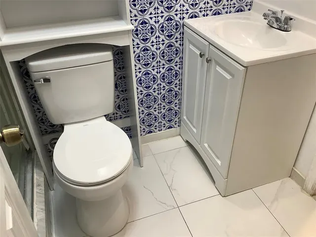 a bathroom with a sink toilet and vanity