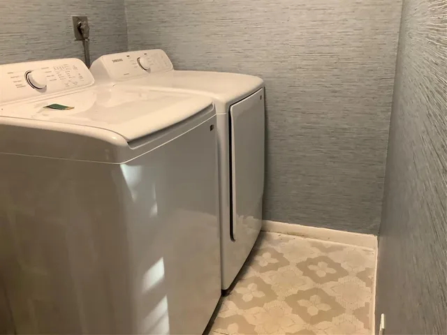 an empty room with wooden floor closet and windows