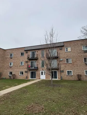 a large building with a big yard and more windows