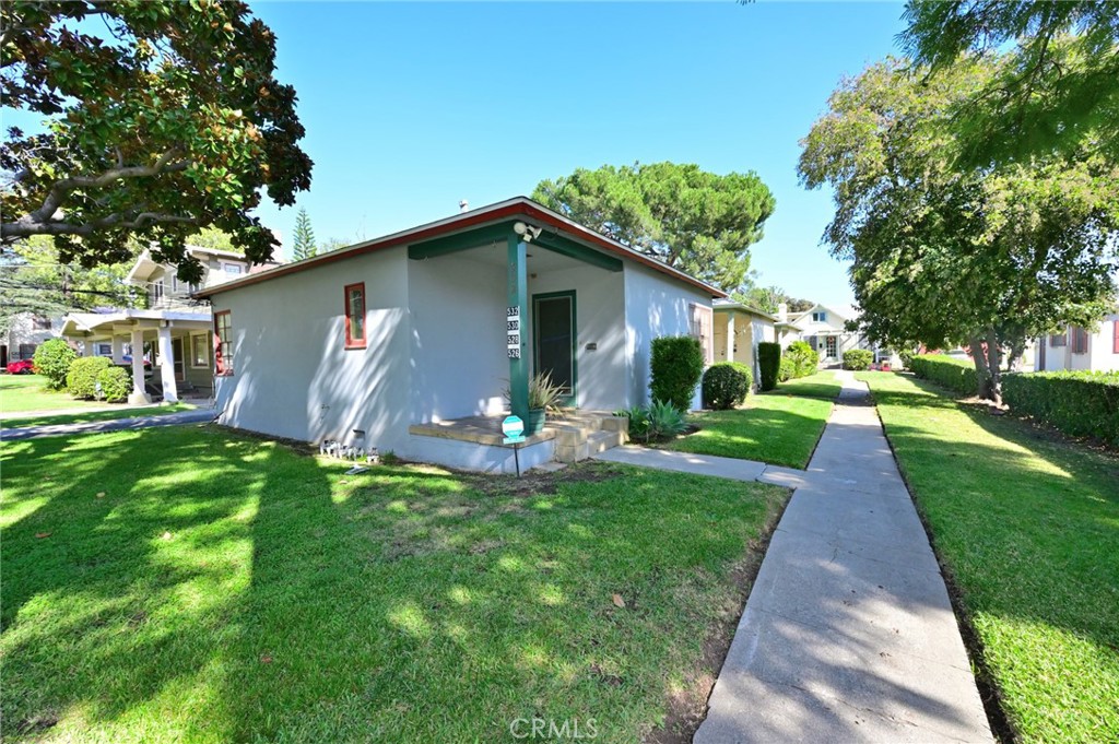 a front view of house with yard and green space